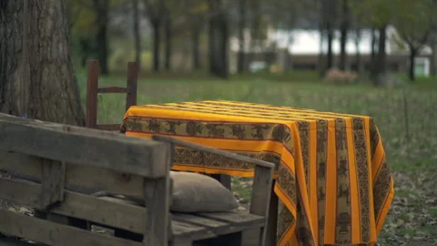 Extra slow and calm slider motion shot of exterior wooden dining table Stock Footage 283520610
