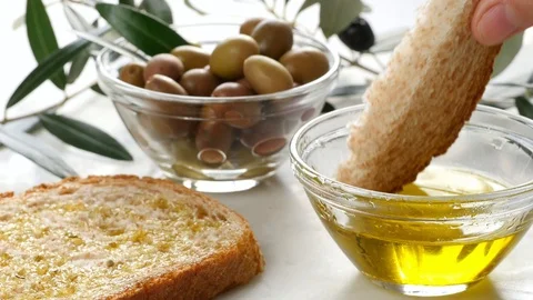 Extra virgin oil, dipping bread in oil, genuine italian ingredient, healthy food Stock Footage 122494488