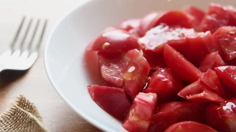 Extra virgin olive oil being poured onto the plate of fresh sliced tomatoe Stock Footage 158724943