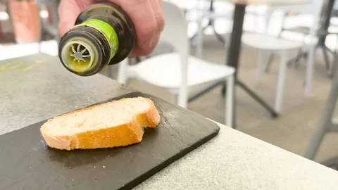 Extra Virgin Olive Oil Drizzled Over Crusty Italian Bread Slice Stock Footage 336520146
