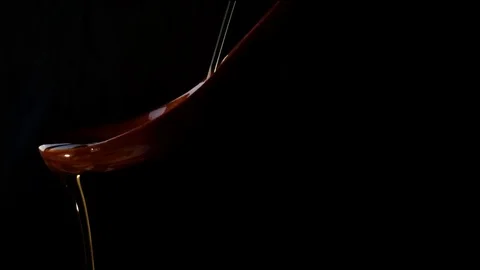 Extra virgin olive oil falling into a wooden spoon. Concept of gastronomy. Stock Footage 113301327