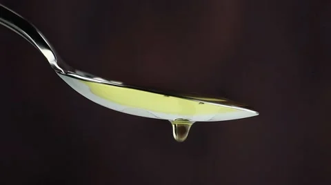 Extra virgin olive oil in a spoon, drops  Stock-Footage 51987250