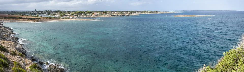 Extra wide angle view of The beautiful Ognina beach in Syracuse with turquois Stock Photos