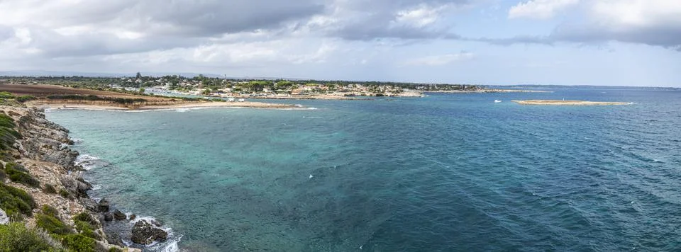 Extra wide angle view of The beautiful Ognina beach in Syracuse with turquois Stock Photos