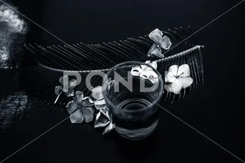 Extracted tincture or extraction of rosemary flower in a glass on wooden surf Stock Photos