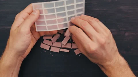 Extracting and Breaking Miniature Red Bricks in Silicone Mold, Top View Video stock 257217214
