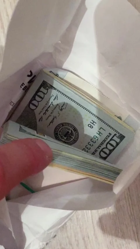 Extracting cash from envelope closely, Detailed view of hand withdrawing large Stock Footage 324877934