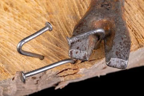 Extracting old nails from a piece of raw wood. Carpentry work in the workshop Stock Photos