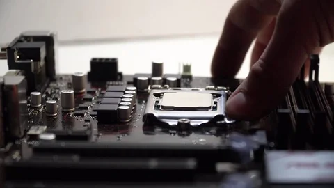 Extraction of the central processor from a motherboard socket. Stock Footage 83210536