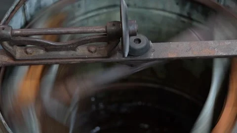 Extraction of honey from honeycombs of nesting frames in honey extractor Stock Footage 249627250