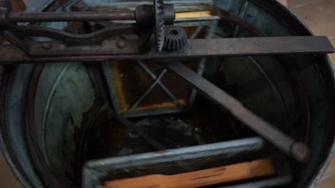 Extraction of honey from honeycombs of nesting frames in honey extractor Stock Footage 252663739