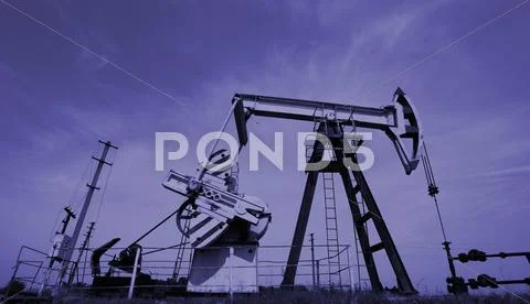 Extraction Of Oil. Pump Jack And Oil Wellhead. Toned.