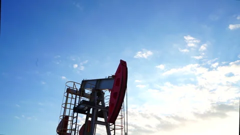 Extraction of petroleum. Oil Pump Jack on Sunset at Oil Field Stock Footage 325046648