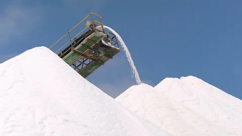 Extraction of salt, clouds coloured by pink salt pan below, close shot. 스톡 동영상 100778779