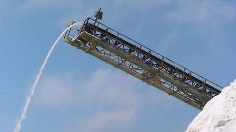 Extraction of salt, clouds coloured by pink water, medium shot. Salt Industry. Stock Footage 100779918