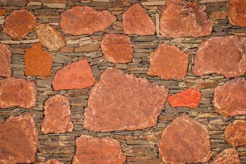 Extraordinary red stony wall texture as an background Stock Photos