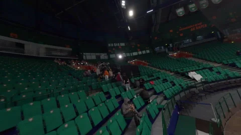 Extras with crew fill single section of vast stadium Video stock 303278356