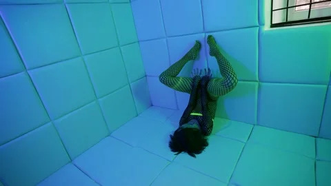 Extravagant sexy lady dressed net suit is posing strange in room Stock Footage 151468809