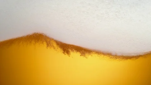 Extream close-up beer in glass. Foam moving. Slow Motion. Stock Footage 72852313
