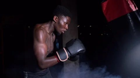 Extrem close up boy boxer hitting punching bag Stock Footage 115793263