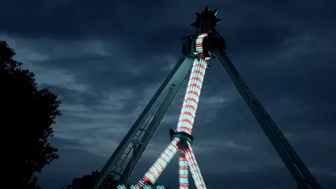 Extreme attraction in amusement park, with changing lights, in dark in work Stock Footage 112419981