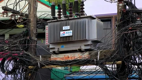 Extreme cable clutter on power pole at trafo in Thailand. Stock Footage 321584035