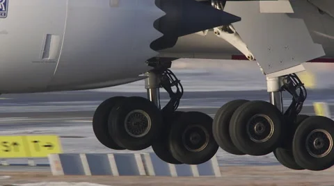 Extreme close up airplane landing gear wheels runway slow motion Stock Footage 58158070