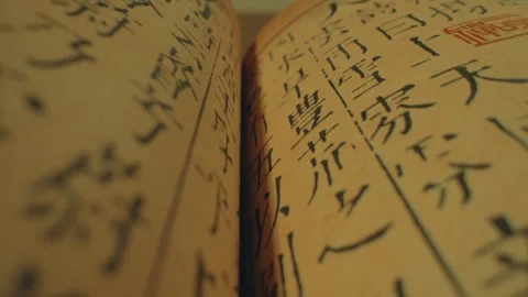 Extreme Close-up of Ancient Book Pages with Traditional Calligraphy Stock Footage 337419960