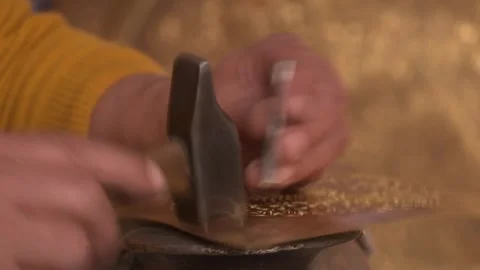 Extreme Close-up of Artisan Hands Engraving Intricate Patterns on Brass Metal Stock Footage 329674448