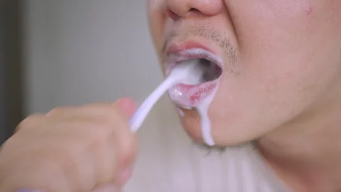 Extreme Close-up of Asian Man Brushing His Teeth with White Foam,  Stock Footage 337769326
