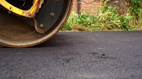 Extreme Close Up of Asphalt Roller Compacting Surface – 4K Stock Footage 311073006