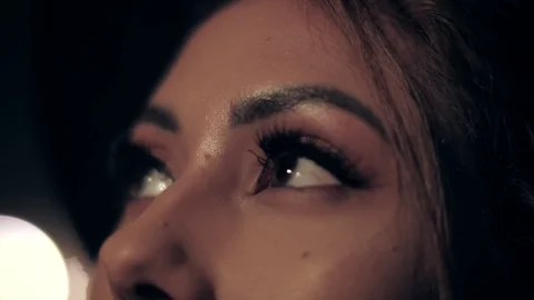 Extreme close up beautiful female eyes contemplating colorful neon lights Stock Footage 126248620