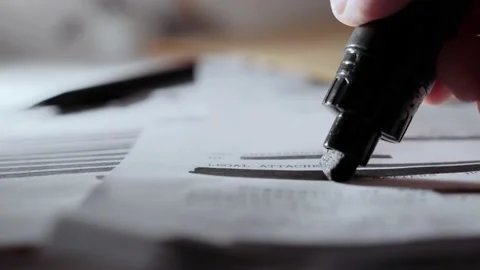 Extreme close up as black marker draws black line on redacted censored text memo Vídeo Stock 199977685