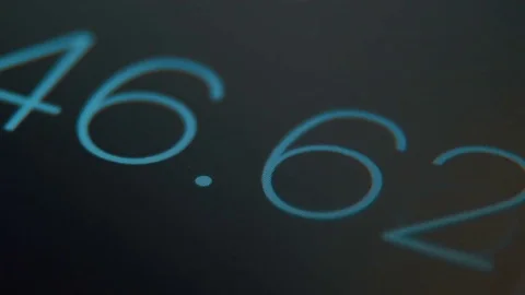 Extreme close-up of the black screen of digital stopwatch with blue running.. Stock Footage 70564920