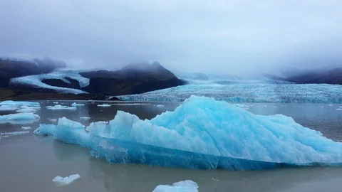 Extreme Close up of Blue Iceberg fly over Stock-Footage 128663675