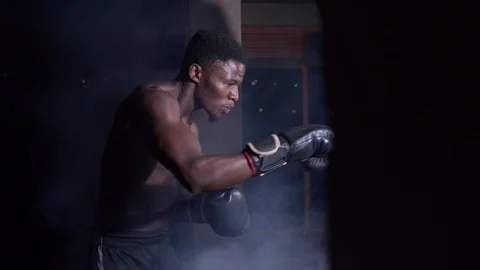 Extreme close up boy boxer hitting punching bag Stock Footage 115794044