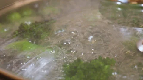 Extreme Close-up of Broccoli Boiling in Pan with Lid. Stock Footage 345927493