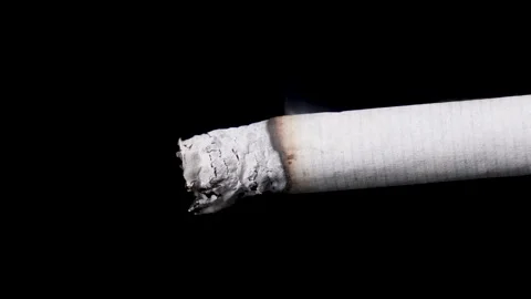 Extreme close-up burning cigarette with smoke and ash, isolated background. Stock Footage 147075238