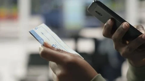 Extreme close up of bus ticket held by traveler in shuttle terminal Stock Photos