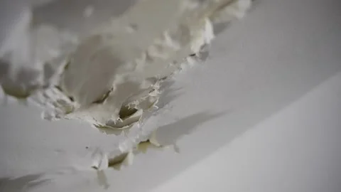 Extreme close up as camera moves across dry ceiling paint as it is peeling off Stock Footage 268799945
