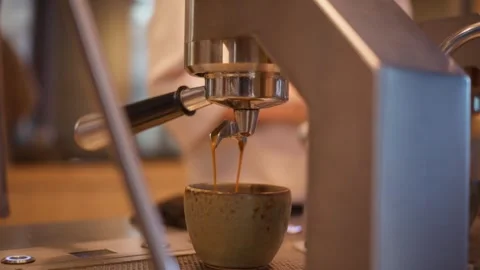 Extreme Close-Up Captures Espresso Streaming into Ceramic Cup in Aarhus Video stock 340894613