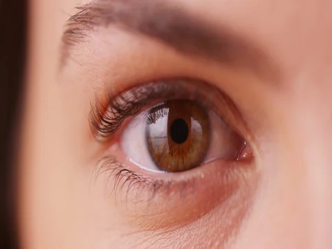 Extreme close up of Caucasian millenial's brown eye blinking Stock Footage