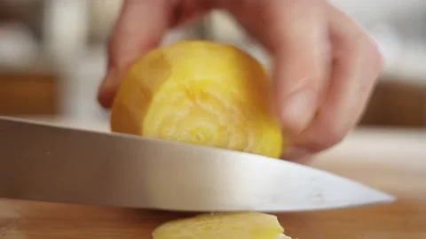 Extreme close up of chef slicing yellow beet Video stock 153290959