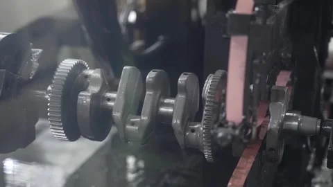 Extreme close up of a CNC grinding machine polishing an engine crankshaft with Stock Footage 333377471