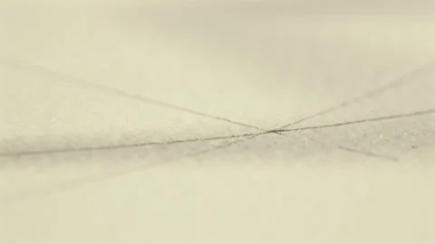 Extreme Close Up of Compass Drawing Circular Arc on Paper Stock Footage 339009404