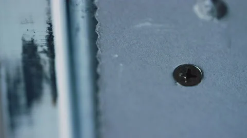 Extreme close up of construction panel with screw head and cuts Video stock 165440421