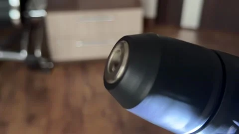 Extreme close up of a cordless power drill chuck rotating with its work light on Stock Footage 321700416