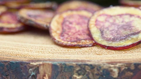 Extreme close-up of crispy fried native Peruvian purple potato chips. Stock Footage 341440637