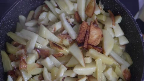 Extreme close-up of crispy golden fried potato slices with oil Stock Footage 333517260