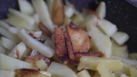 Extreme close-up of crispy golden fried potato slices with oil Stock Footage 333517262